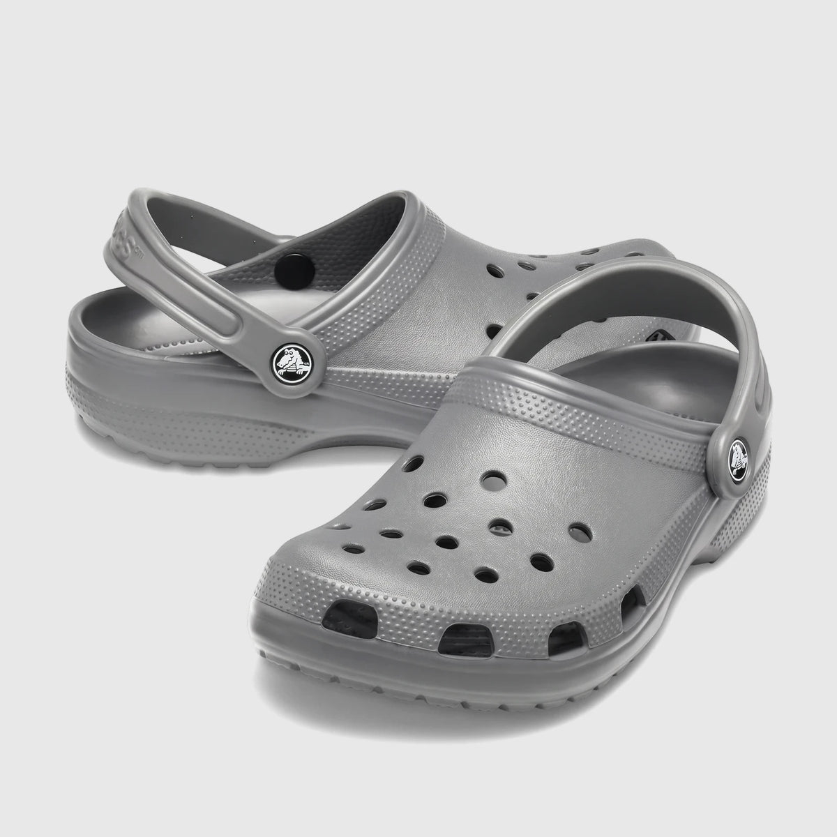 Pair of Crocs Classic clogs in slate grey, showcasing the iconic lightweight, slip-on design with ventilation ports and a