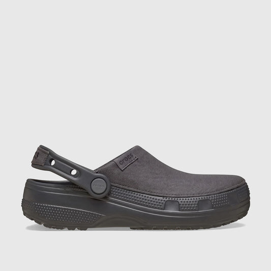 A black Crocs Classic Crafted Clog, model 211354-0LD, shown from a side view. Features include its durable construction and