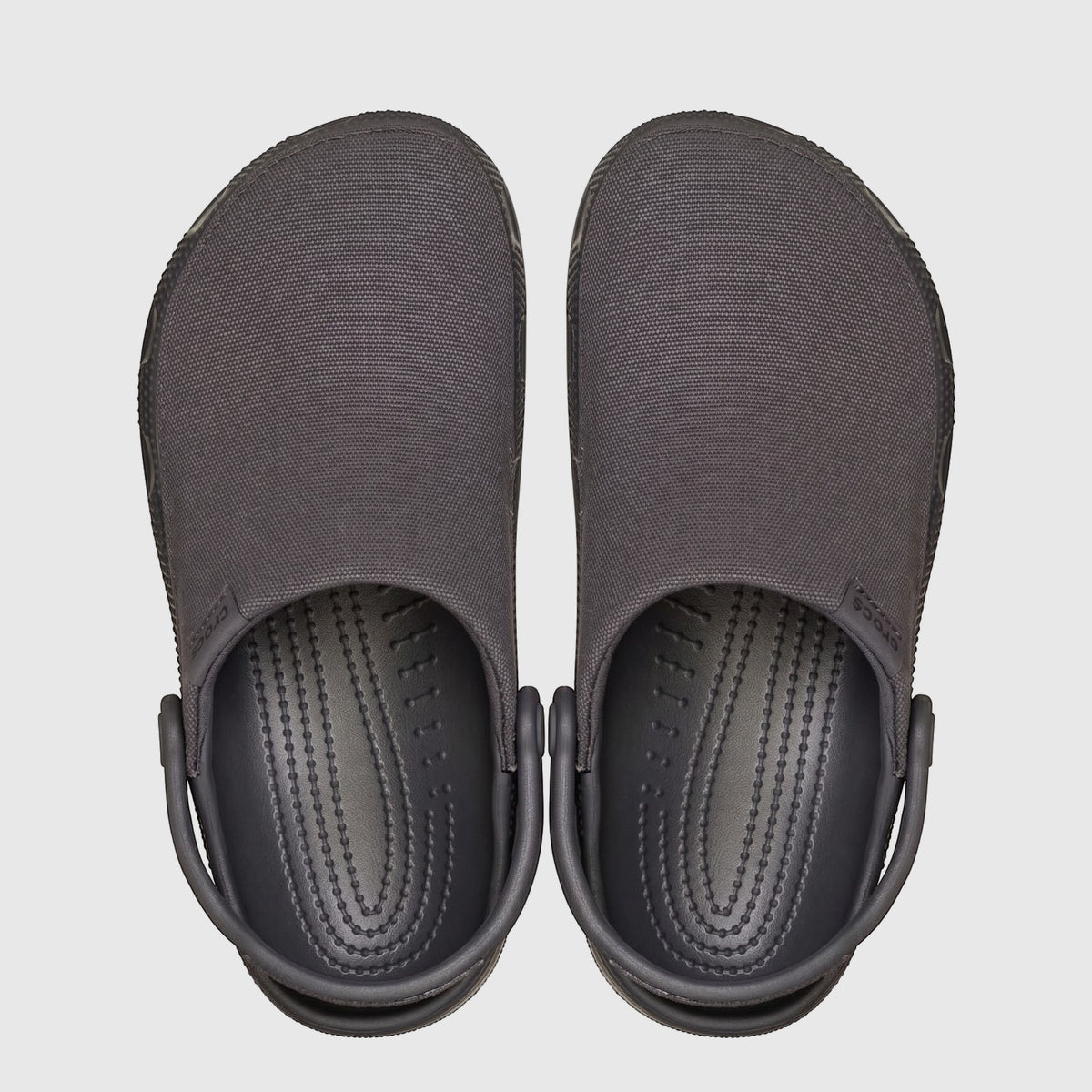 Pair of dark grey Crocs Classic Crafted Clogs with canvas uppers, shown from a top-down perspective.