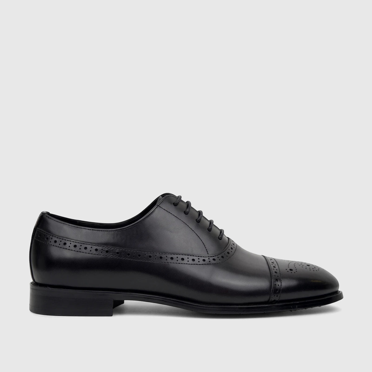 Black leather men's cap-toe oxford dress shoe by Fabino with intricate brogue detailing and classic lace-up style.