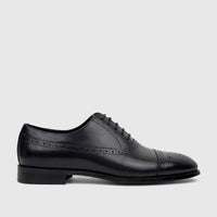 Black leather men's cap-toe oxford dress shoe by Fabino with intricate brogue detailing and classic lace-up style.