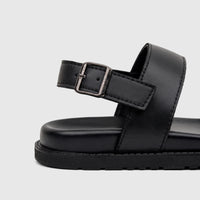 Close-up view of a black Fabino men's leather comfort sandal, highlighting the textured sole and metal buckle details.