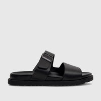 Black leather men's comfort sandal with two wide straps, an adjustable buckle, and a chunky sole, shown in profile view.