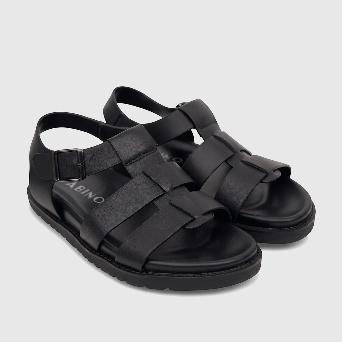 Pair of Fabino men's black leather comfort sandals with woven straps and a buckle closure, displayed from an elevated