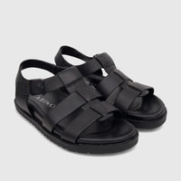 Pair of Fabino men's black leather comfort sandals with woven straps and a buckle closure, displayed from an elevated