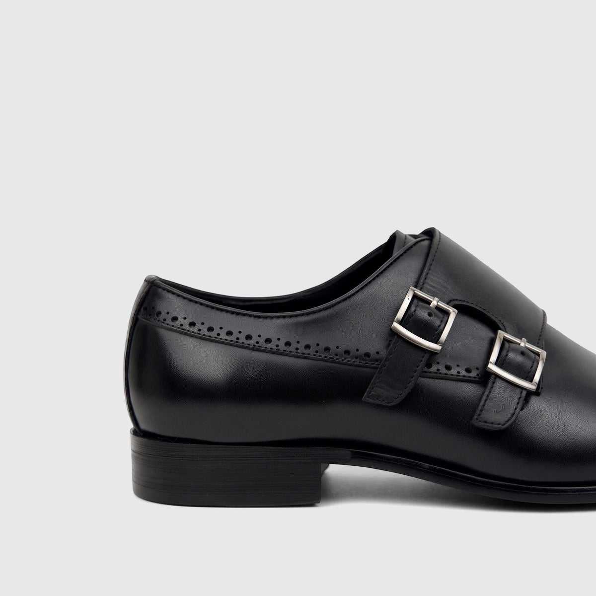 Black men's Fabino dress leather double monk strap shoe, visible from the side, showcasing its silver buckles and brogue