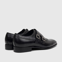 Black leather men's Fabino double monk strap dress shoes with silver buckles and brogue detailing, side view.