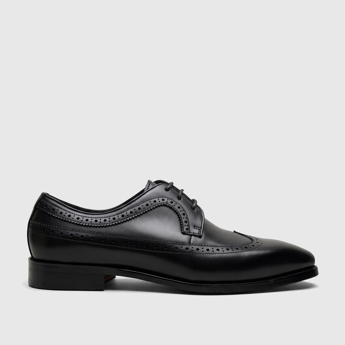 A single Fabino Men's black leather lace-up brogue dress shoe, presented in a side profile view, showcasing its detailed