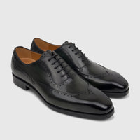 Fabino Men's black leather lace-up wingtip oxford dress shoes with a glossy finish, displayed on a white background.