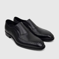 Black leather men's slip-on dress shoes, featuring brogue detailing and a polished finish, displayed on a clean surface.