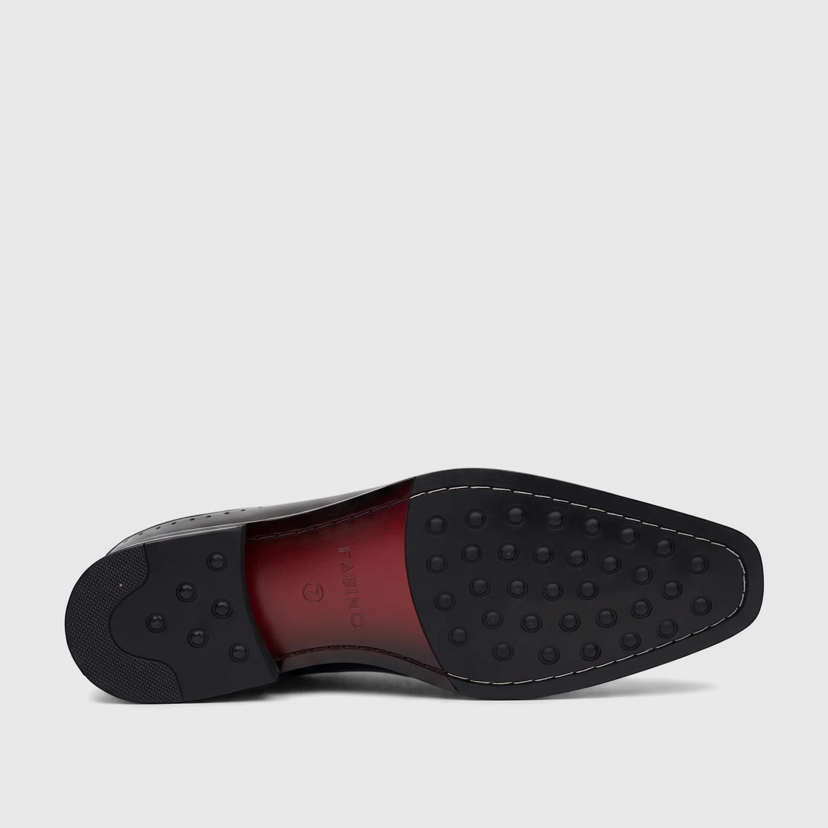 Sole view of a black patent leather Fabino men's dress shoe, featuring a prominent red middle section and black rubber