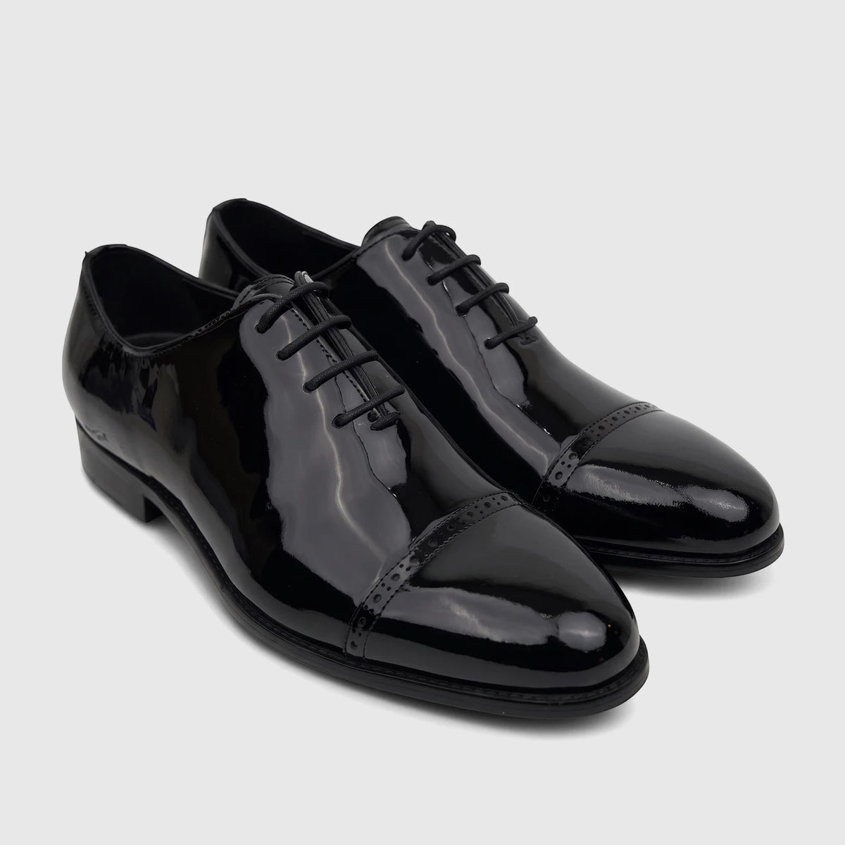 Fabino men's black patent leather dress shoes with cap toe detailing and laces, displayed on a clean surface.