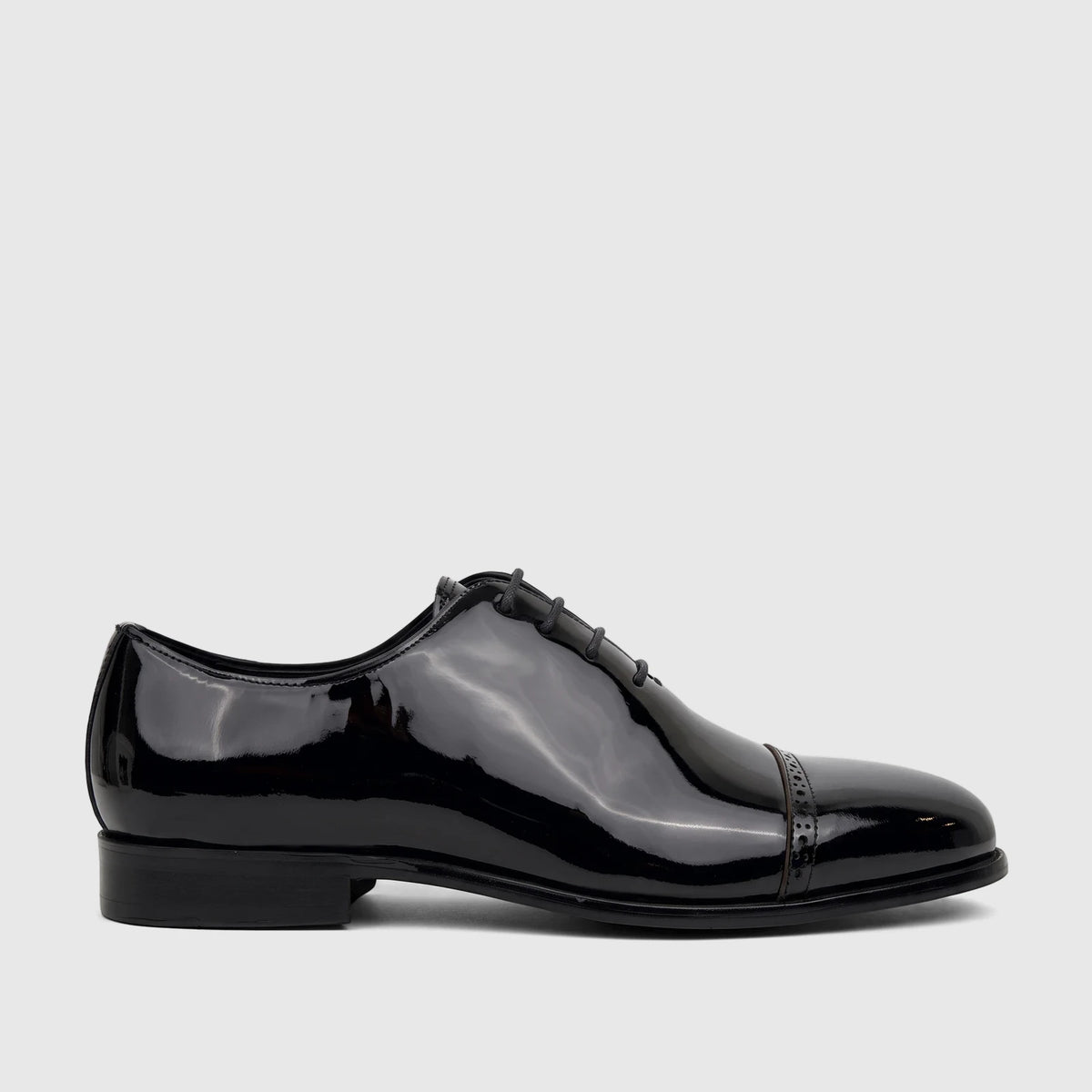 Fabino men's black patent leather lace-up dress shoe, visible in a side profile view, showcasing its glossy finish and cap