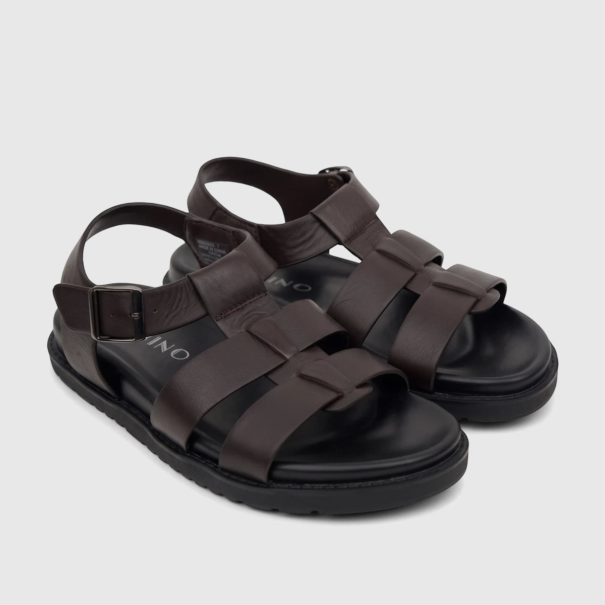 A pair of Fabino men's brown leather comfort sandals, featuring a woven strap design and ankle buckle, presented at a slight