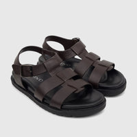 A pair of Fabino men's brown leather comfort sandals, featuring a woven strap design and ankle buckle, presented at a slight