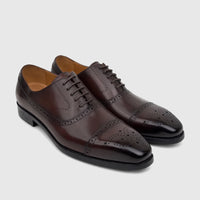 A pair of Fabino men's coffee brown leather lace-up dress shoes with brogue detailing and black soles.