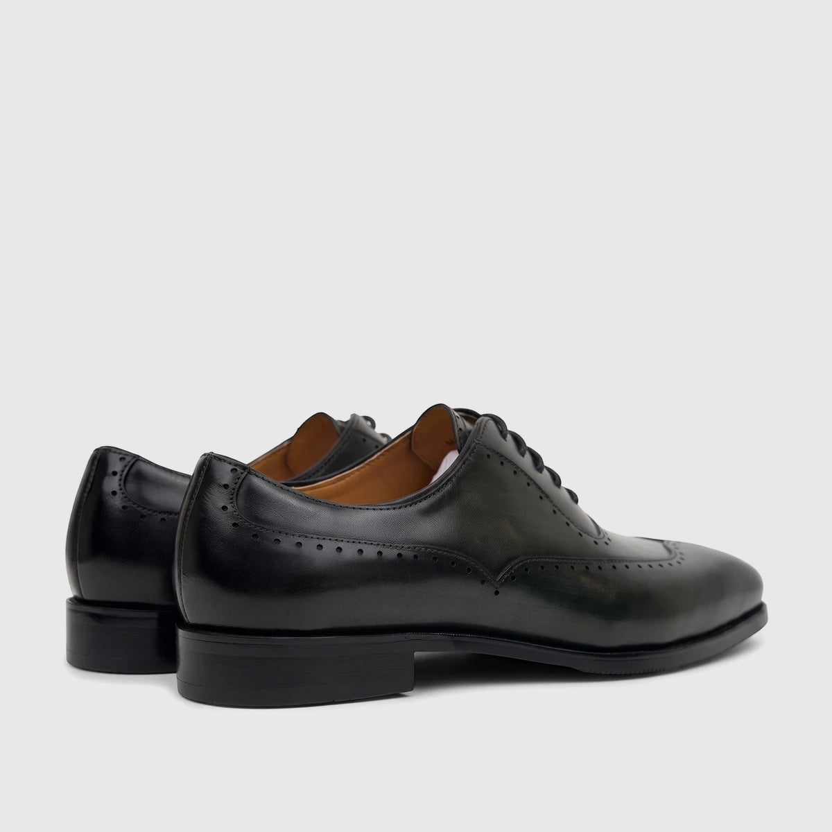 Fabino Men's dark green leather lace-up dress shoes with brogue detailing, shown from a side-rear perspective.