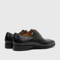 Fabino Men's dark green leather lace-up dress shoes with brogue detailing, shown from a side-rear perspective.