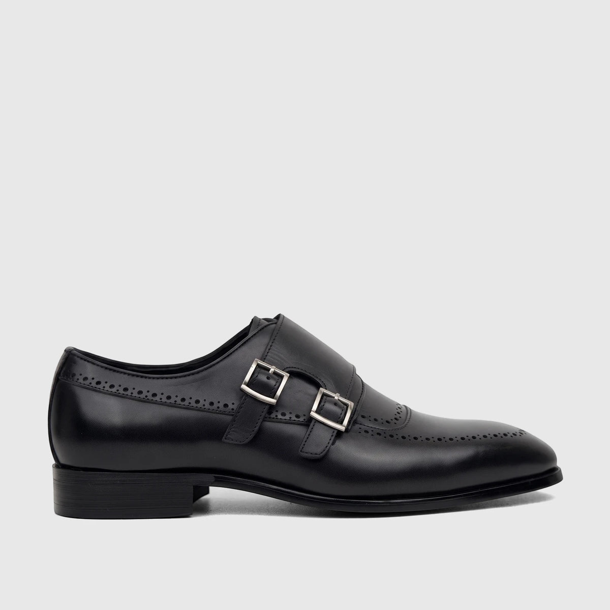 A black leather men's Fabino double monk strap dress shoe, featuring silver buckles and intricate brogue detailing,