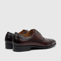 Fabino Men's M3220206 Coffee FB32 dress shoes, made of polished leather with brogue details, seen from a rear-side view.