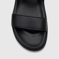 Close-up of a black Fabino men's leather comfort sandal, showcasing the textured strap and smooth footbed.