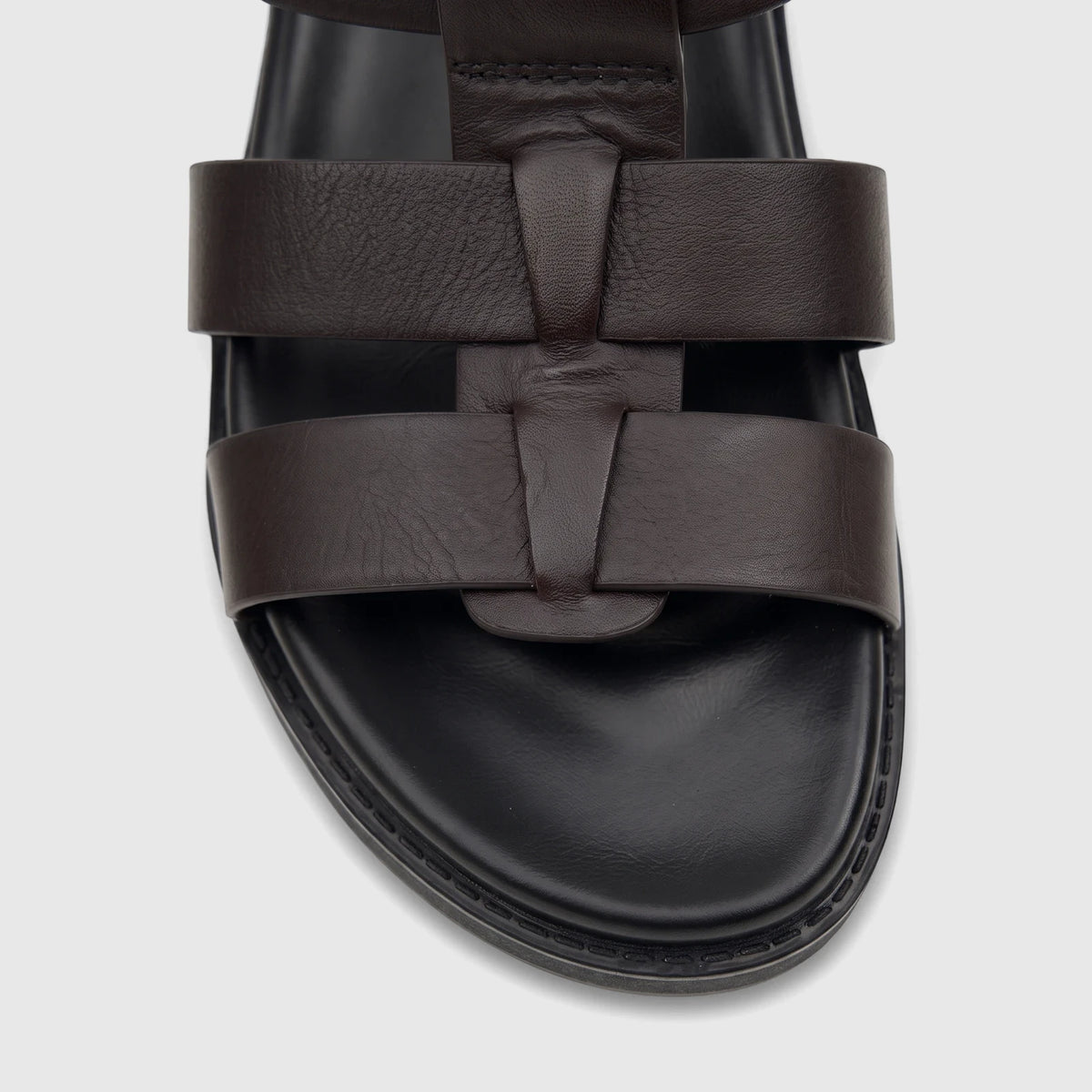 Close-up view of a Fabino Men's Leather Comfort Sandal in brown, featuring a T-strap design and a thick black sole.