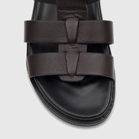 Close-up view of a Fabino Men's Leather Comfort Sandal in brown, featuring a T-strap design and a thick black sole.