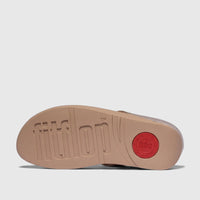 Bottom sole of a beige Fit Flop Ladies Comfort Sandal, featuring the embossed FitFlop logo and a red circular detail.