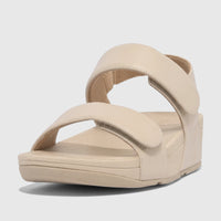Light tan Fit Flop Ladies Comfort Sandal Lulu with adjustable leather back strap, shown from a low-angle side view.