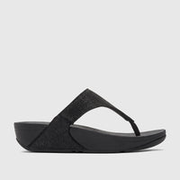 Side profile of a black Fit Flop Ladies Comfort Sandal Lulu Shimmerglitz, featuring a shimmering thong strap and a comfort