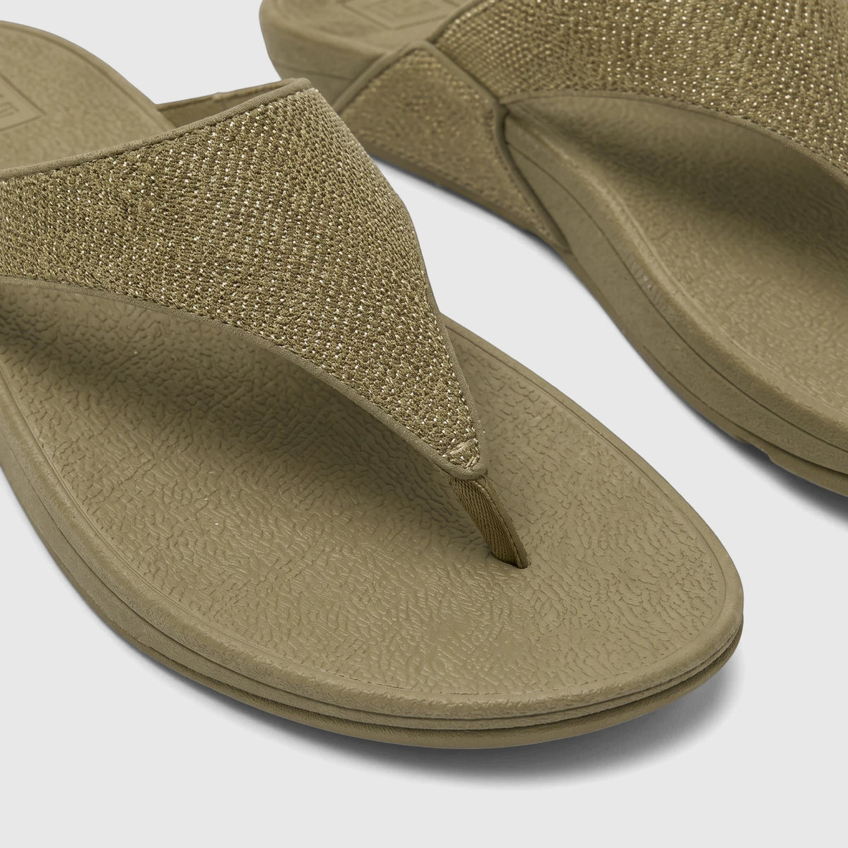Close-up of two deep olive Fit Flop Ladies Comfort Sandal Lulu Shimmerglitz, featuring woven textured straps and comfortable