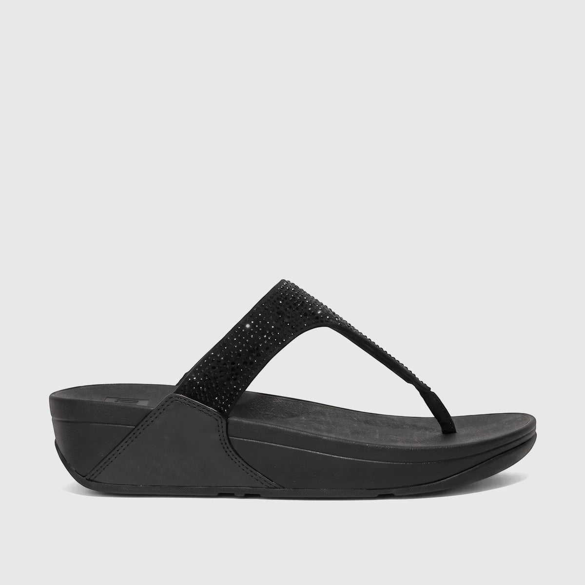 Black Fit Flop Lulu crystal embellished comfort sandal with a platform sole, viewed from the side.
