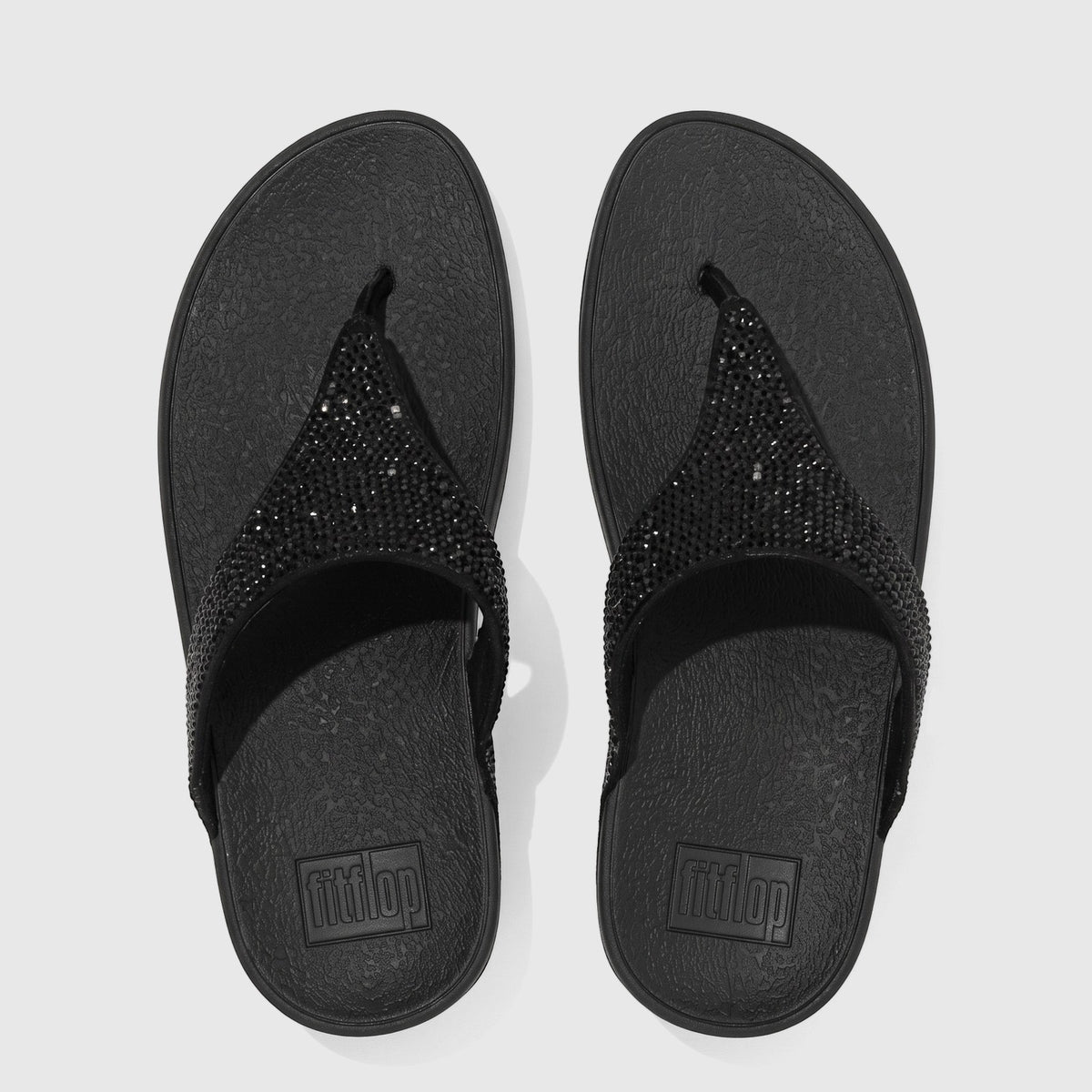 Black Fit Flop Lulu Crystal Embellished comfort sandals. Overhead flat-lay view showing sparkling crystals on textured