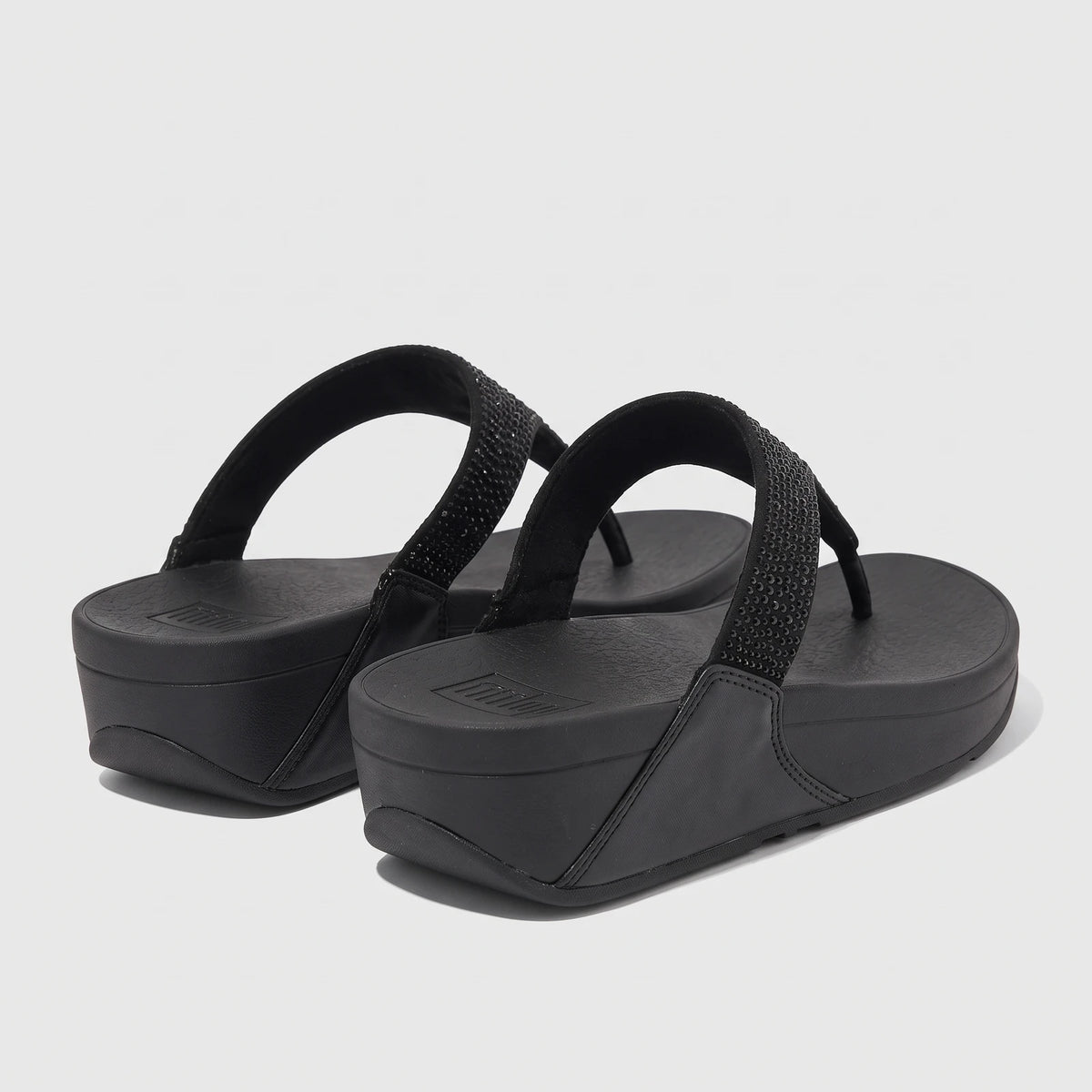 Fit Flop Ladies Lulu Crystal Embellished Comfort Sandal in black with crystal-embellished straps and wedge sole.