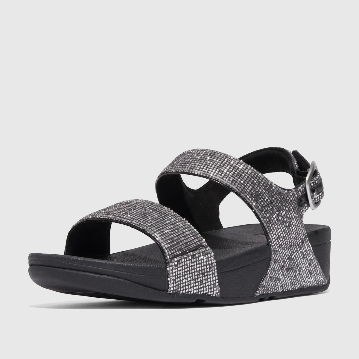 Silver glitter Fit Flop Lulu comfort sandals with a back strap and black soles, shown in a low-angle studio shot.