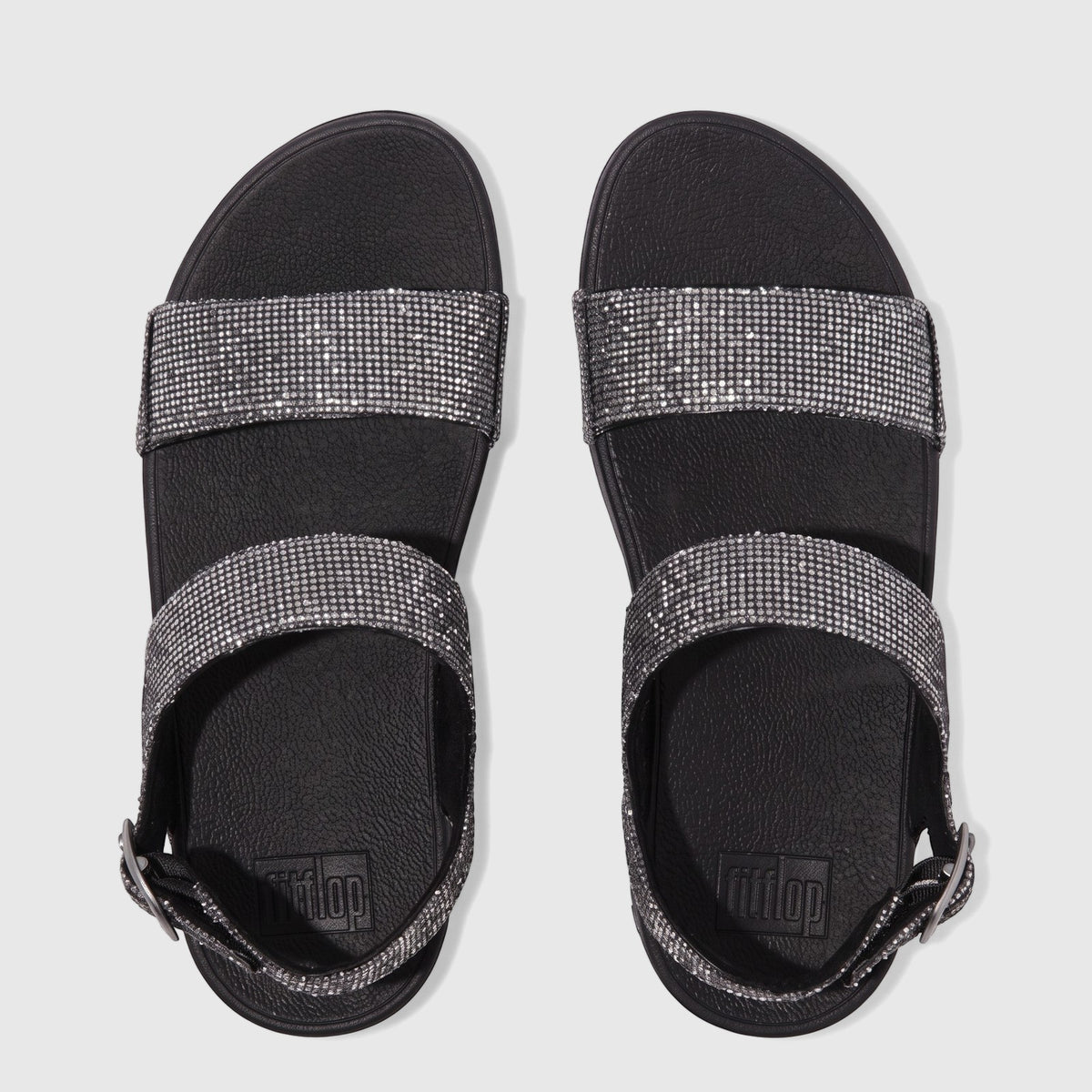Pair of Fit Flop Lulu Glitterball Back Strap sandals in silver and black, viewed from above. Women's comfort sandals with