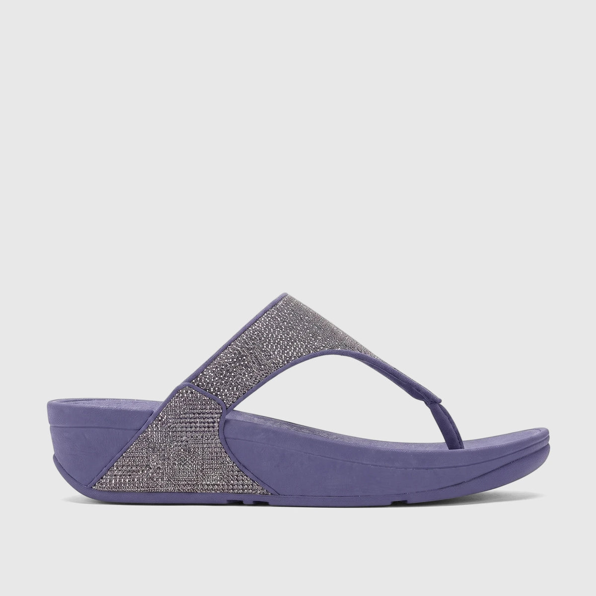 Fit Flop Lulu Shimmerglitz comfort sandals in nightfall blue, featuring a sparkly thong strap and a supportive wedge sole.