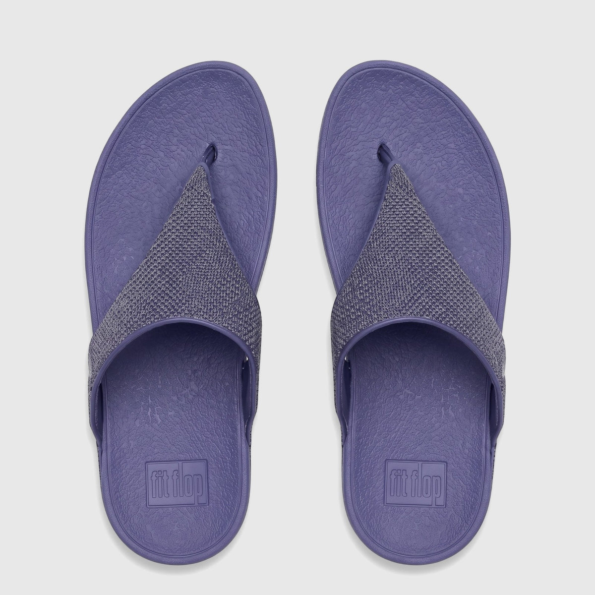 Pair of Fit Flop Lulu Shimmerglitz comfort sandals in Nightfall Blue, viewed from above, with textured gray straps.