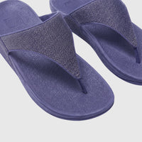 Close-up of a pair of Fit Flop Lulu Shimmerglitz Nightfall Blue comfort sandals with textured straps and a platform sole.