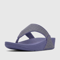 Fit Flop Lulu Shimmerglitz comfort thong sandal in nightfall blue with a sparkling gray strap, side view.