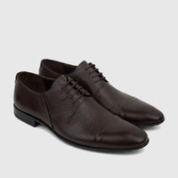 A pair of dark brown Florsheim Imperial men's lace-up oxford shoes with a textured upper and polished cap toe.