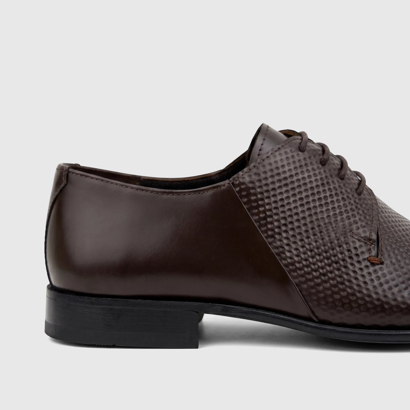 Close-up of a chocolate brown Florsheim Imperial men's lace-up shoe, featuring smooth and textured leather sections with a
