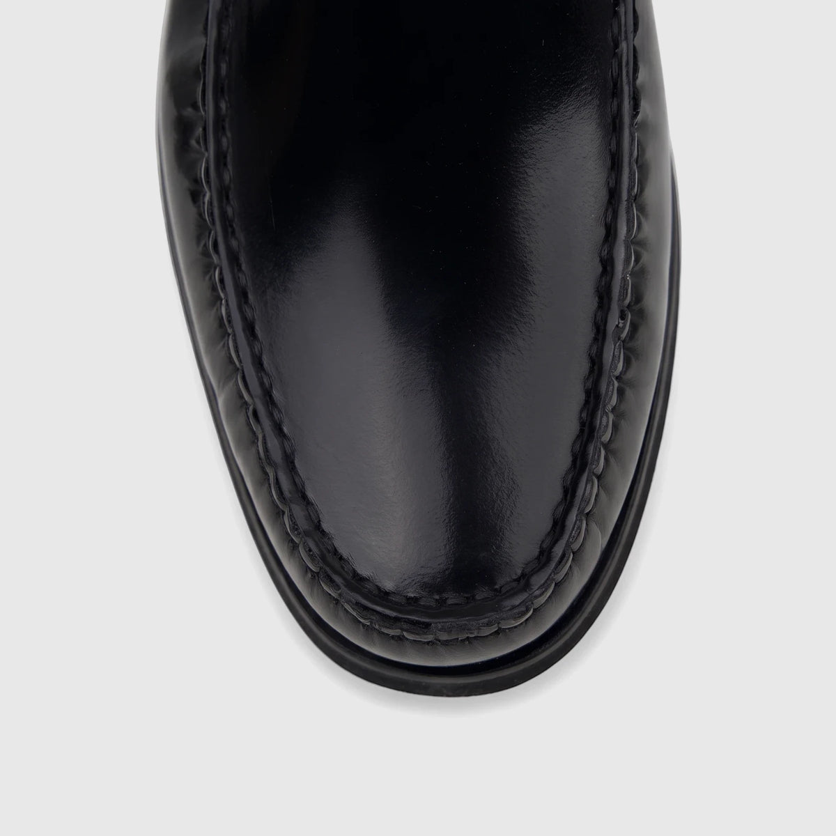 Close-up top-down view of a black Florsheim Men's Berkley Flex Venetian slip-on loafer shoe made of shiny leather.
