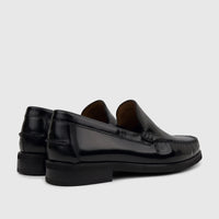 Black shiny leather men's slip-on loafers from Florsheim, showing the rear and side view on a white background.