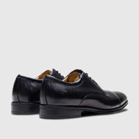 Florsheim Men's Comfortech Dress Lace Up Chateau black leather shoes from a rear-side view with cap-toe and laces.