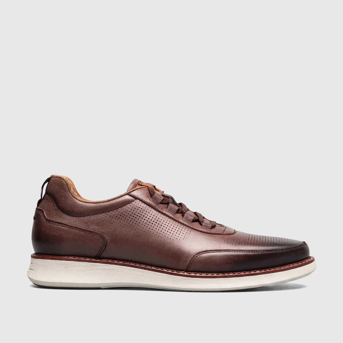 Florsheim Men's Launch Elastic Lace Slip On shoe in dark brown leather, featuring perforations and a white sole, viewed from