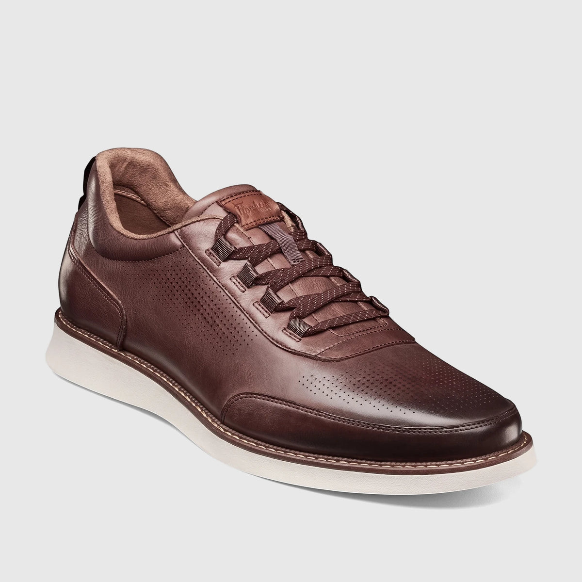 Florsheim Men's Launch Elastic Lace Slip On shoe in T.Moro dark brown leather with perforated details and a white sole.