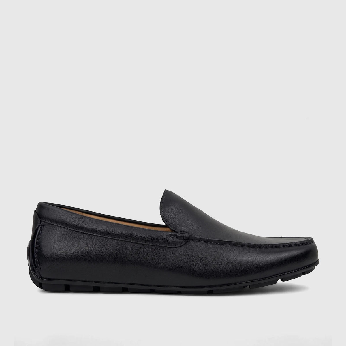 Black leather Florsheim Men's Loafer Motor Moc shoe, model 181153/001 FT42, featuring classic stitching, presented in a side