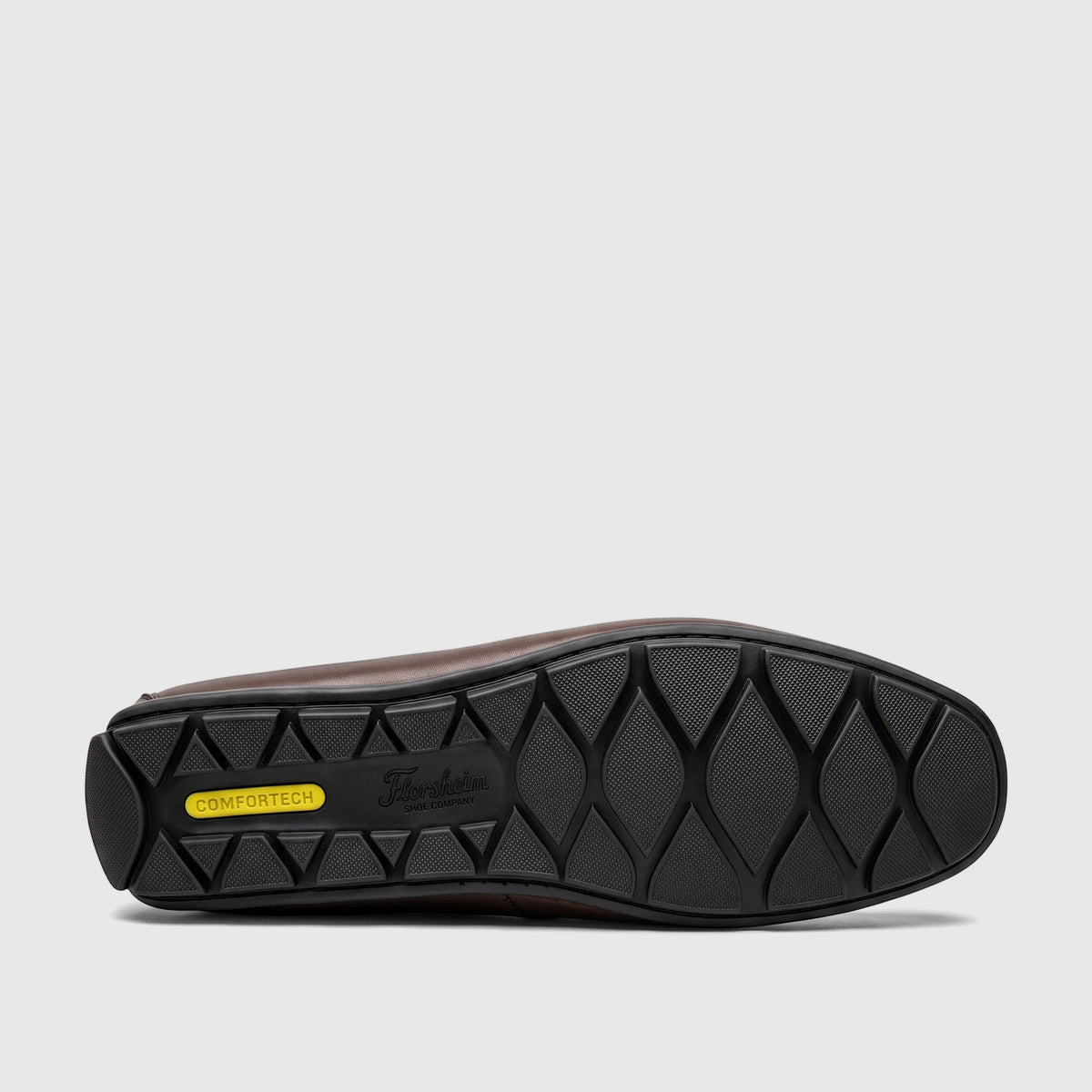 View of the black sole of a dark brown Florsheim Men's Loafer Motor Moc, featuring 'COMFORTTECH' and textured grip patterns.