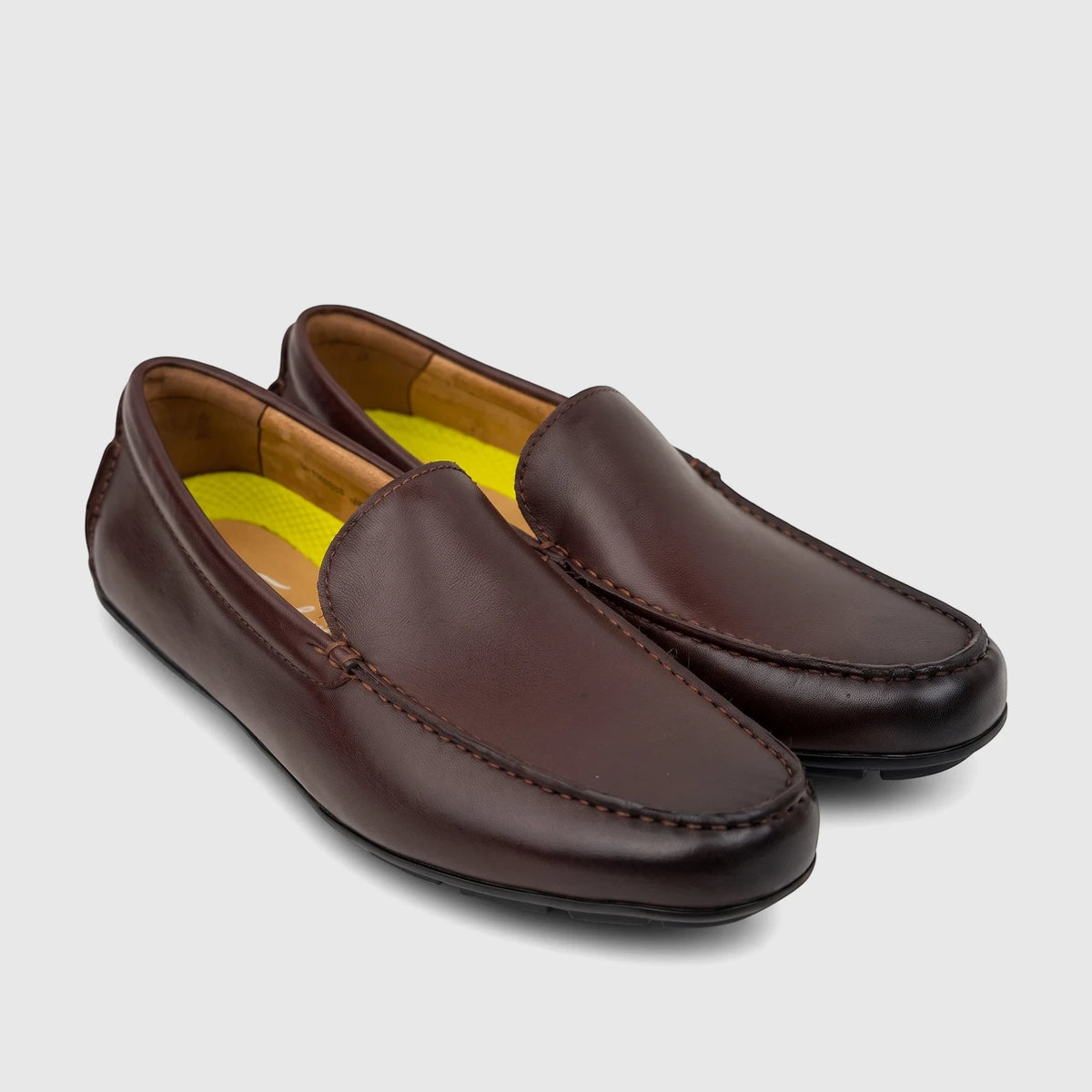 A pair of Florsheim Men's Motor Moc loafers in dark brown leather, featuring visible stitching and a relaxed slip-on design.